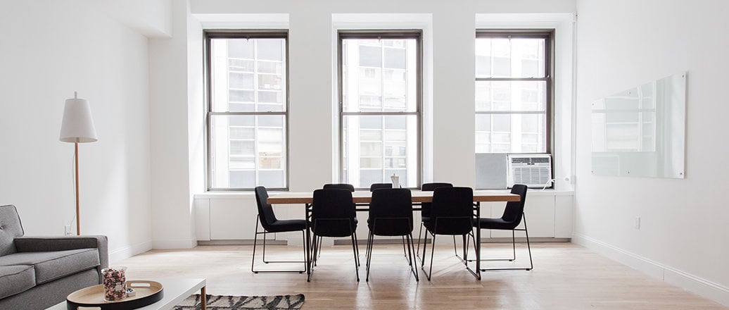 white room with three vertically sliding windows