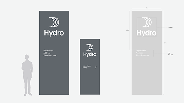 pylons with logo and text in dark blue and light gray, various sizes, size of person to scale. pylons with logo and text in dark blue and light gray, various sizes, size of person to scale.