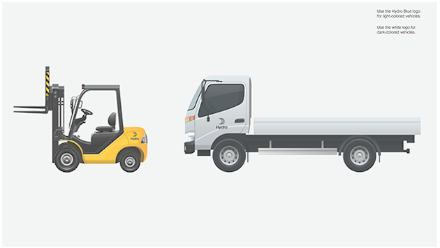yellow forklift with small dark logo above rear wheels, lorry with logo centered on cab door.