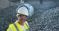a woman wearing a hard hat and safety goggles
