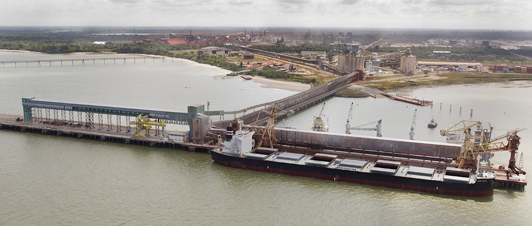 Ship on the Vila do Conde Port. Alunorte refinery is behind. Ship on the Vila do Conde Port. Alunorte refinery is behind.