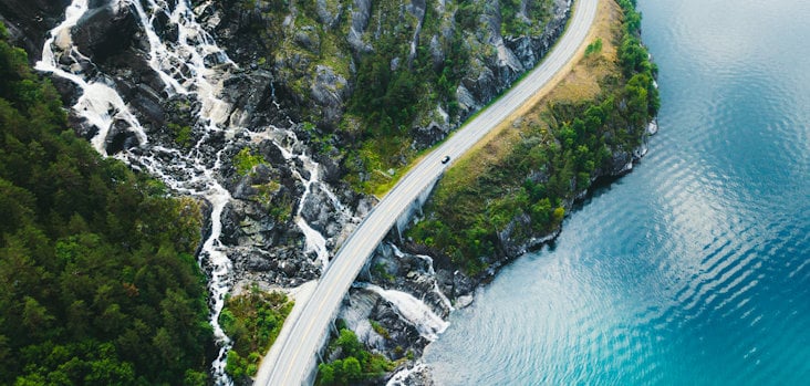 Car driving along a coastal road Car driving along a coastal road