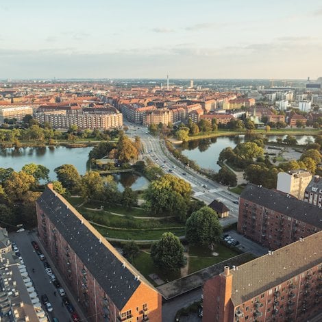 cityscape with a river and green parks