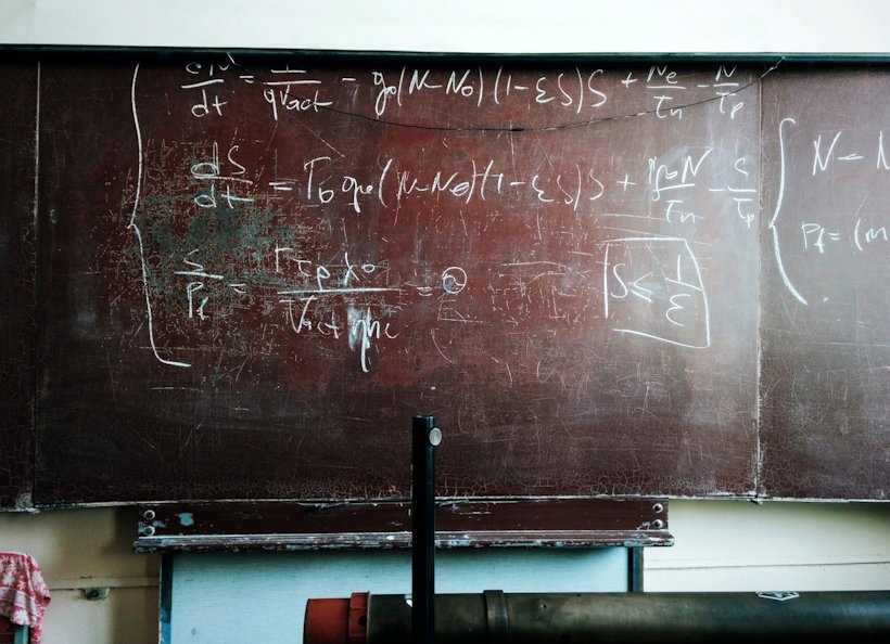 a worn blackboard with science equations a worn blackboard with science equations