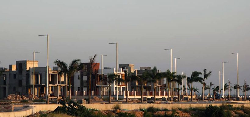 residential buildings, light poles and palms